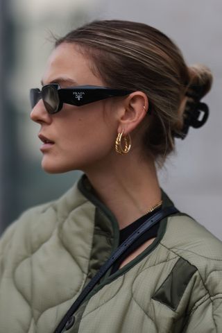 Woman wearing Prada sunglasses with a claw clip in her hair