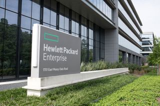Hewlett Packard Enterprise sign on grass, outside a glass-fronted office, edge on to the viewer. The address on the sign is 1701 East Mossy Oaks Road