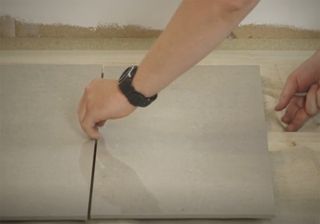 man placing a tile