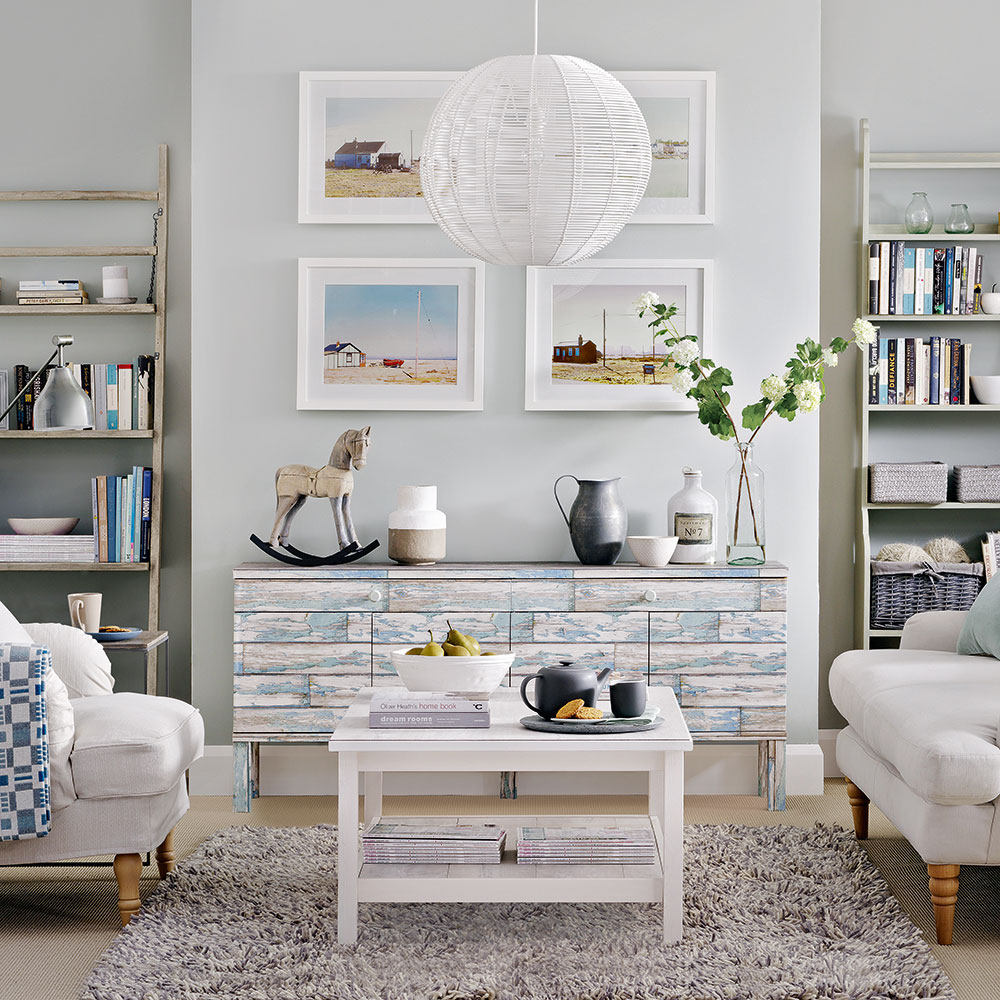 white living room with armchairs and book shelves