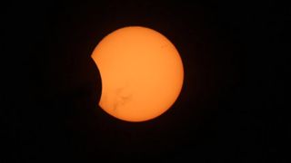 The moon appears to take a noticeable bite out of the sun in this view of the partial solar eclipse visible from Australia on April 29, 2014. This image was provided by the Virtual Telescope Project.