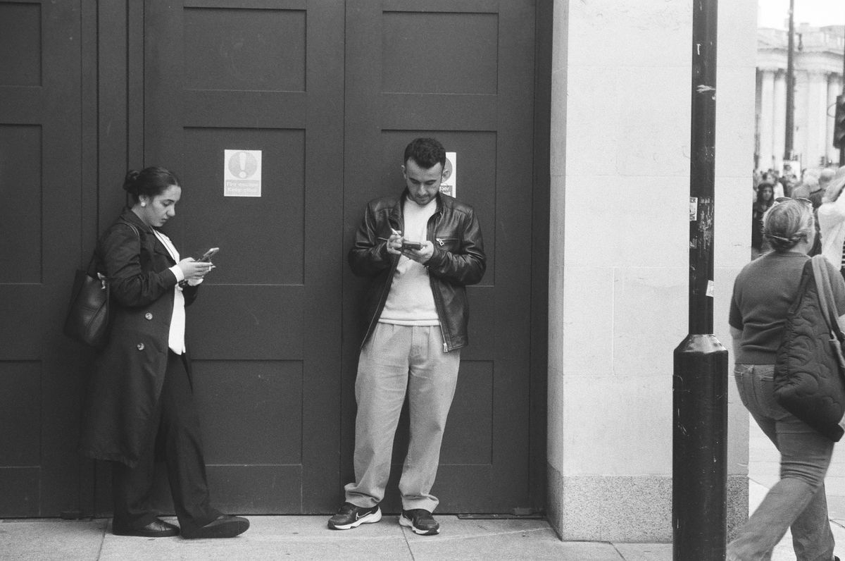 Sample image of Kentmere Pan 200 showing street scene of people smoking in central London