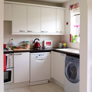 kitchen room with cabinets and washing machine