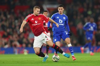 MANCHESTER, ENGLAND - OCTOBER 30: Matthijs de Ligt of Manchester United controls the ball under pressure from Bilal El Khannouss of Leicester City during the Carabao Cup Fourth Round match between Manchester United and Leicester City at Old Trafford on October 30, 2024 in Manchester, England. (Photo by Nathan Stirk/Getty Images)