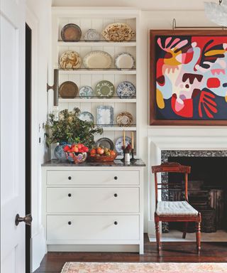 corner of living room with shelves full of plates