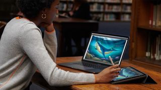 Woman using laptop and tablet