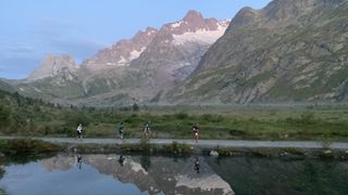 Runners in the UTMB reflected in Lac Combal