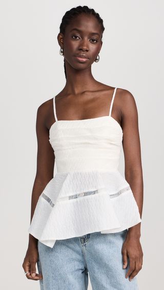 a model wears a white peplum tank top
