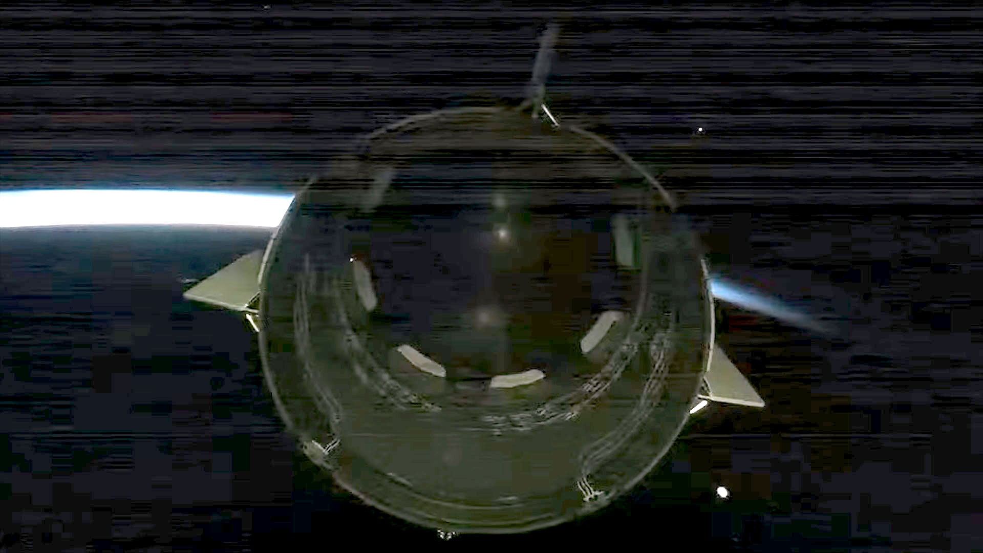 A space capsule seen from behind flies into an orbital sunrise over Earth