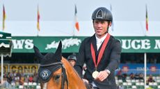 Scott Brash in front of the grandstand at Spruce Meadows after winning the grand prix on Hello Jefferson.