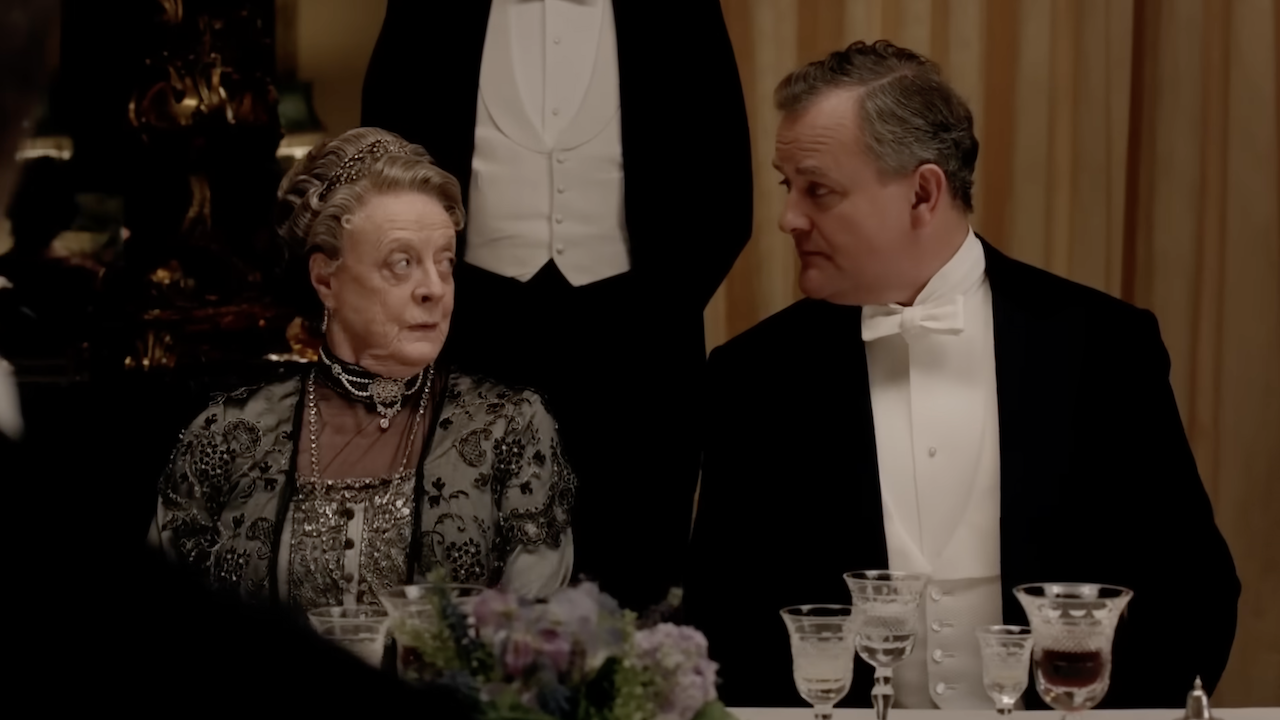Downton Abbey&#039;s Robert and Violet Crawley looking at each other during dinner