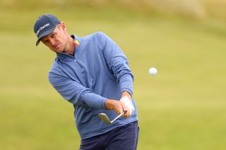 Justin Rose hits a wedge shot from around the green