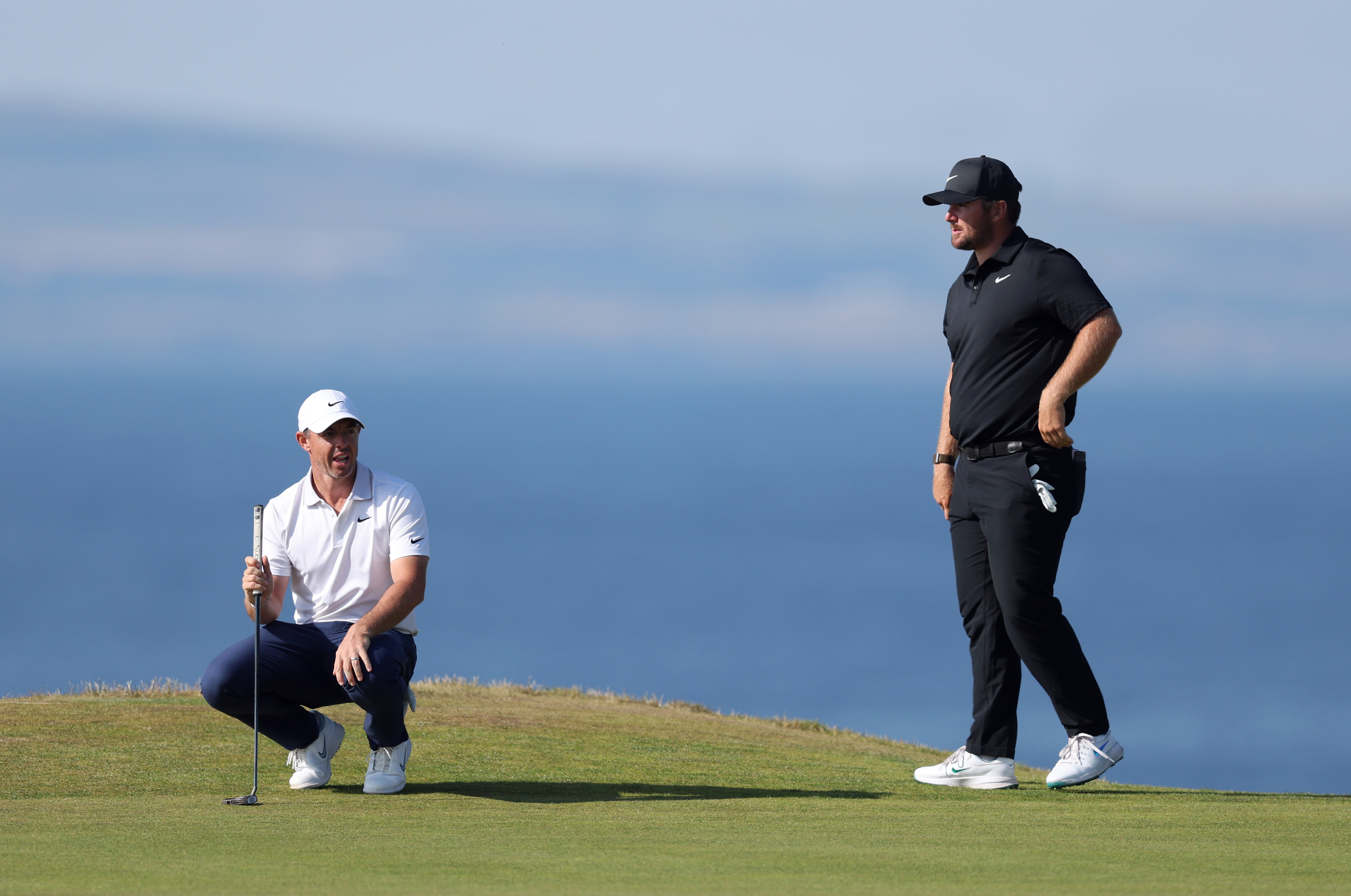 Rory McIlroy and Chris Gotterup line up a putt