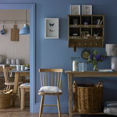 hallway with wooden flooring and indigo blue wall