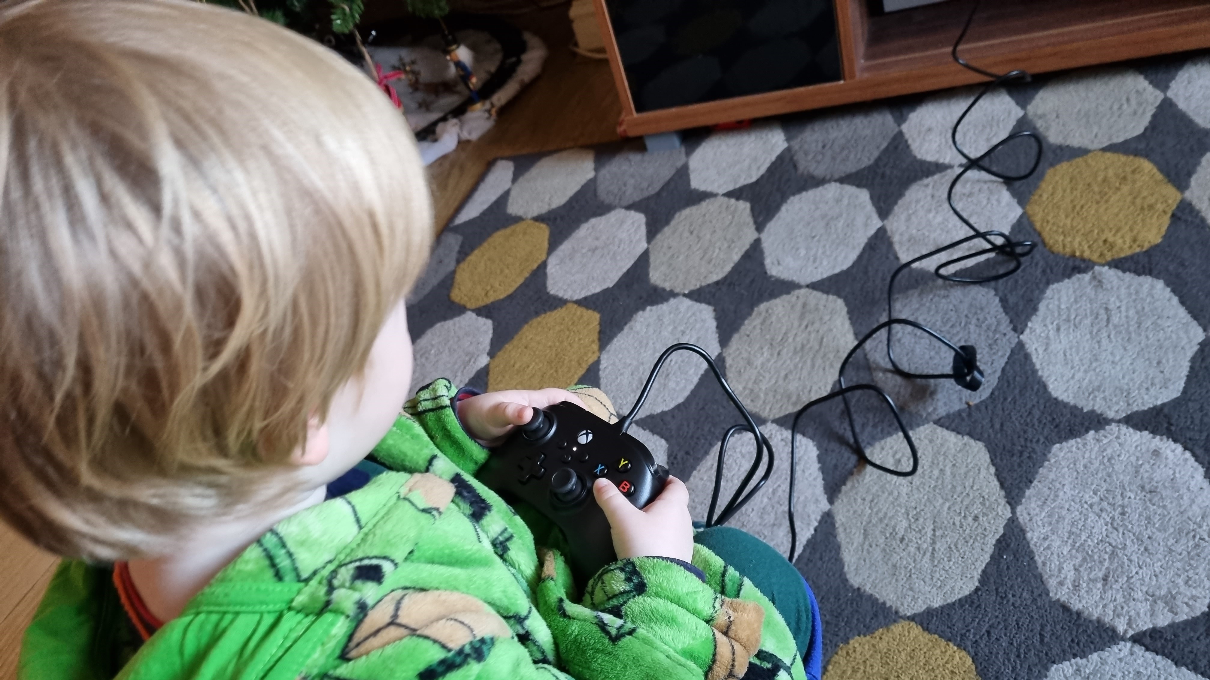 Child playing with PowerA Nano Controller