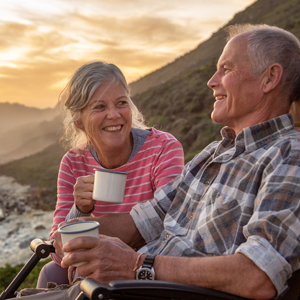 A couple drinking coffee outside