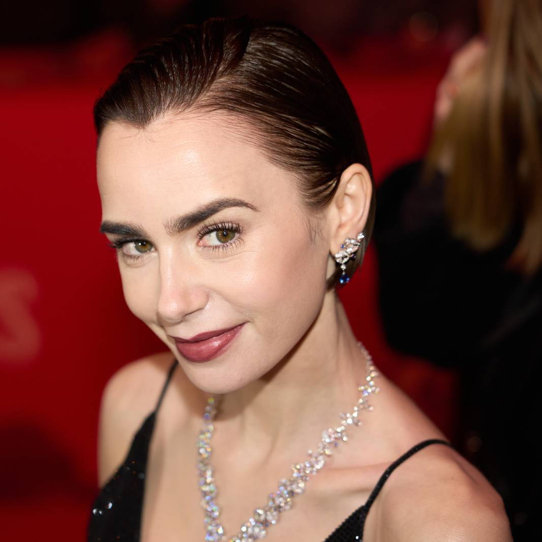 Lily Collins smiles into the camera