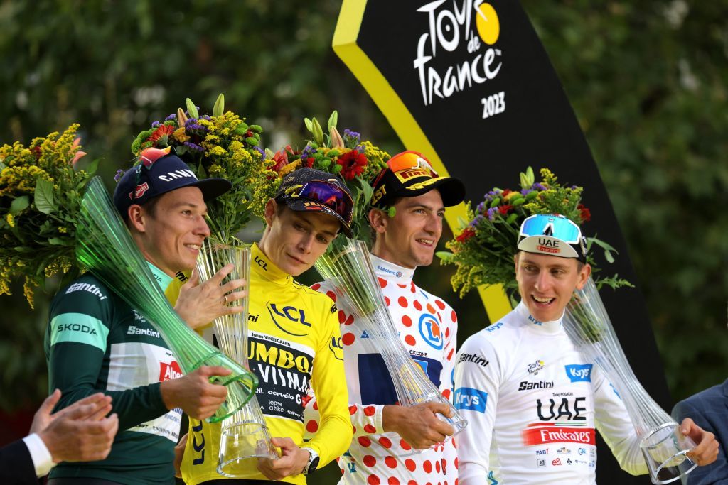 JumboVismas Danish rider Jonas Vingegaard wearing the overall leaders yellow jersey C AlpecinDeceunincks Belgian rider Jasper Philipsen wearing the best sprinters green jersey UAE Team Emirates Slovenian rider Tadej Pogacar wearing the best young riders white jersey and Lidl Treks Italian rider Giulio Ciccone wearing the best climbers polka dot dotted jersey celebrate on the podium after the 21st and final stage of the 110th edition of the Tour de France cycling race 115 km between SaintQuentinenYvelines and the ChampsElysees in Paris on July 23 2023 Photo by Thomas SAMSON AFP Photo by THOMAS SAMSONAFP via Getty Images