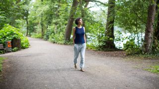 Woman walking outside along a footpath