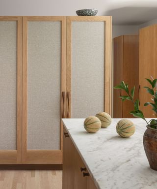 kitchen with natural wood fabric covered cabinets