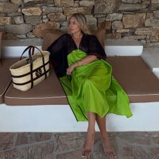 Influencer @lucywilliams02 wears a dill green dress with a wicker bag.