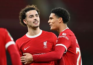 Curtis Jones of Liverpool celebrates with teammate Jarell Quansah after scoring their team's fifth goal during the Carabao Cup Quarter Final match between Liverpool and West Ham United at Anfield on December 20, 2023 in Liverpool, England.