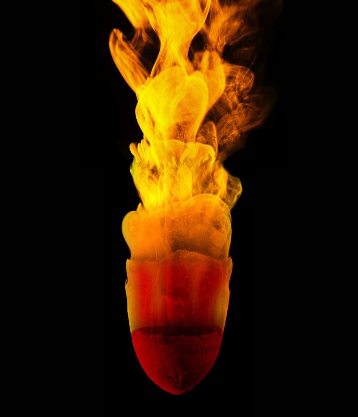 A chunk of clay, attached to a rod, deforms in rushing water as part of one experiment.