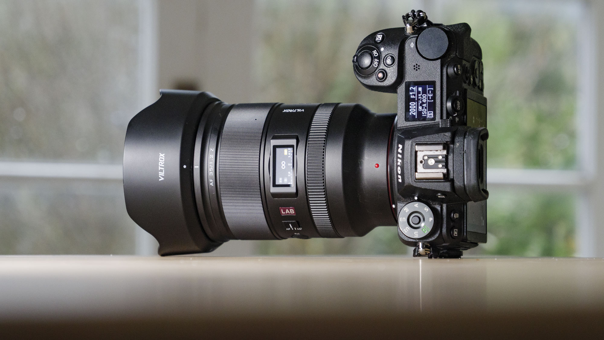 Viltrox AF 35mm F1.2 LAB Z lens for Nikon, attached to a Nikon Z6 II, on a wooden table