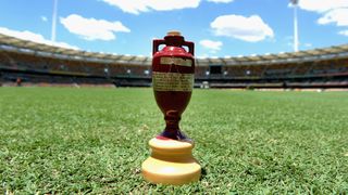 The Ashes urn on a cricket pitch