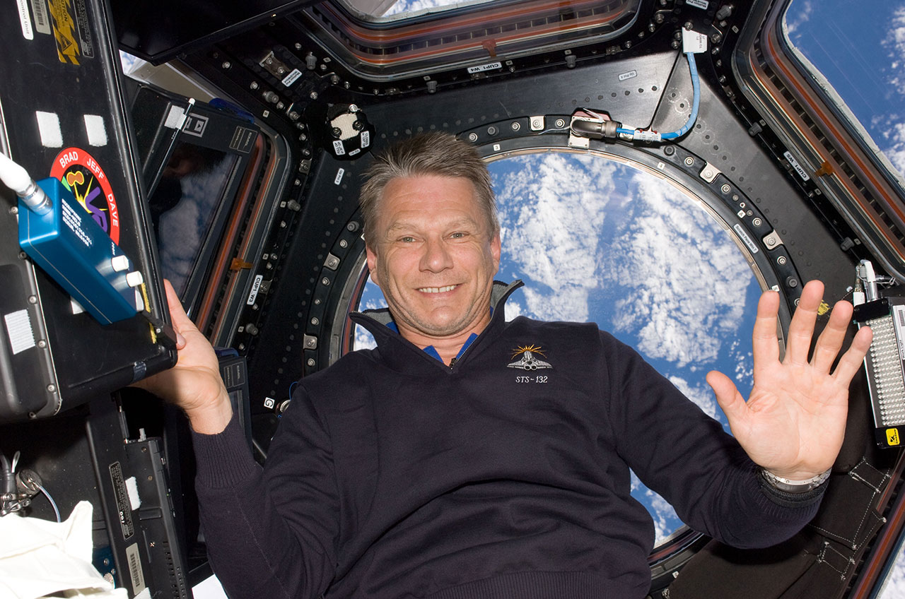 Astronaut Piers Sellers is pictured floating aboard the International Space Station, in front of a window overlooking Earth in May 2010. Sellers, a climate scientist, died on Friday, Dec. 23, 2016.