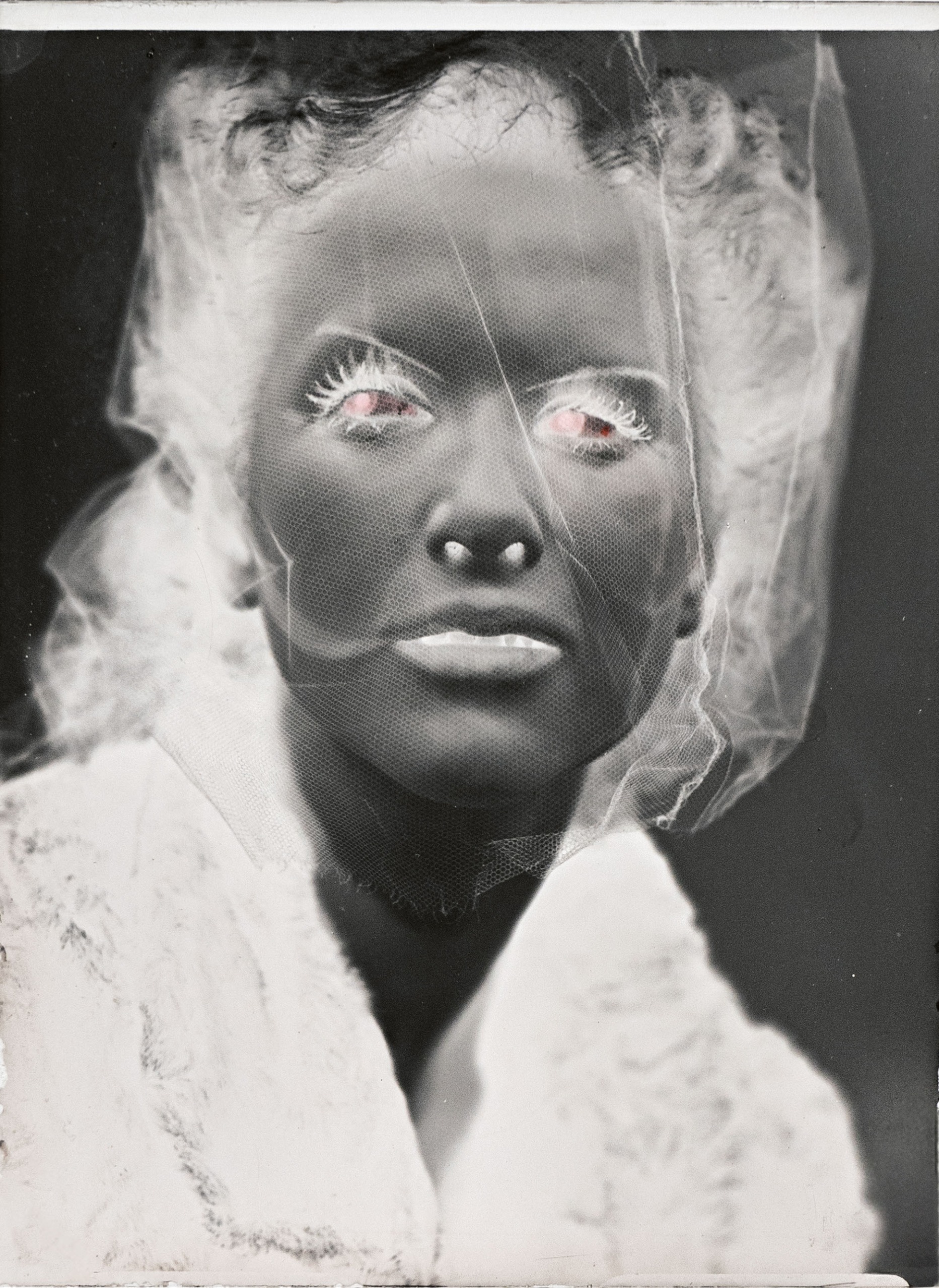 A double-exposed bridal portrait shows a veiled figure with a darkened face and glowing pink eyes.
