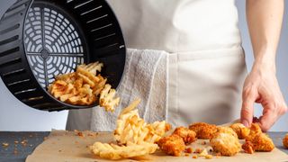 Pouring out foods from air fryer