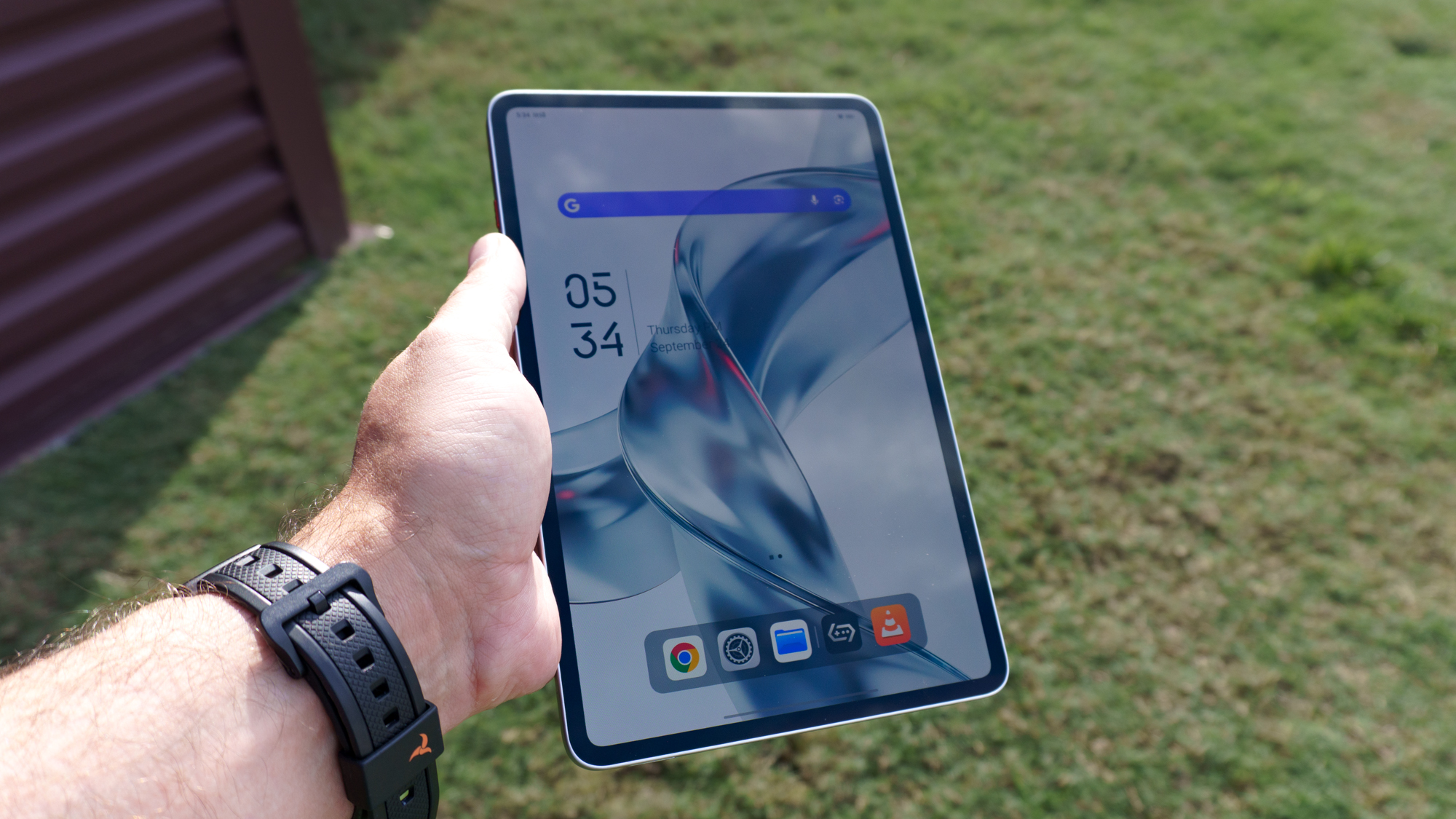 A person holding the RedMagic Astra 2 gamign tablet in portrait mode outside