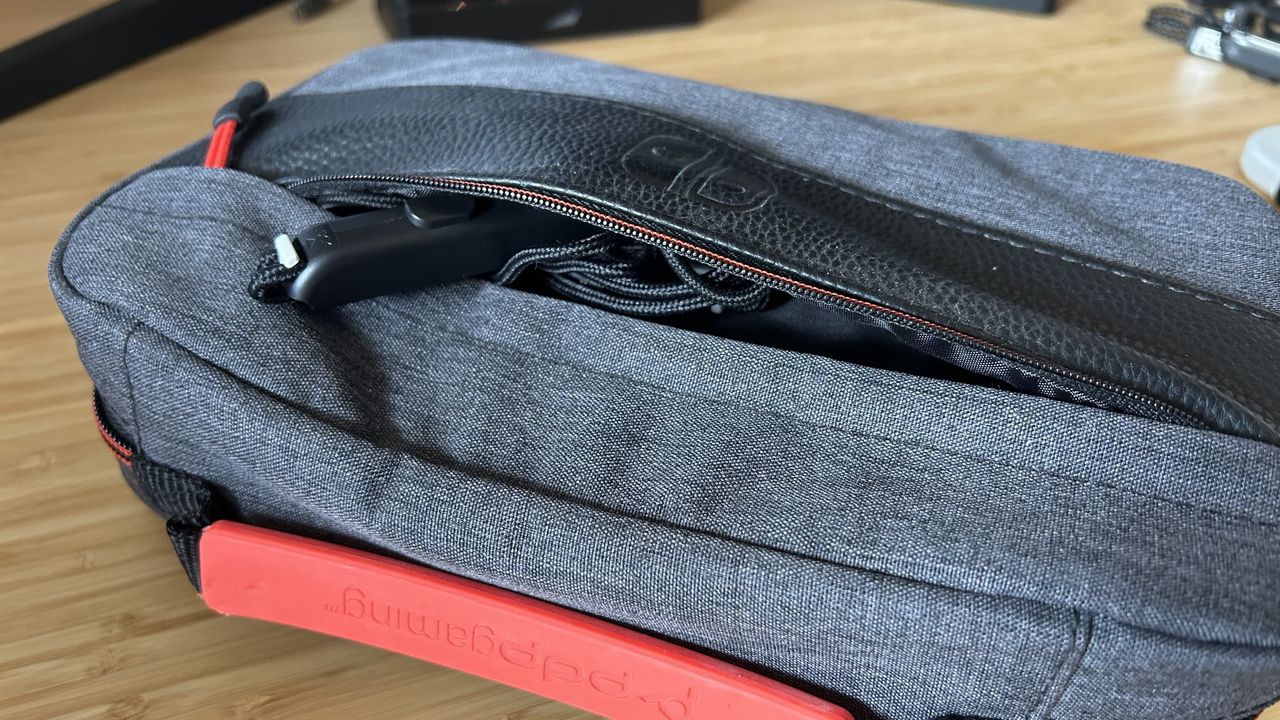 Front pocket of PDP commuter case open with Joy-Con grips inside