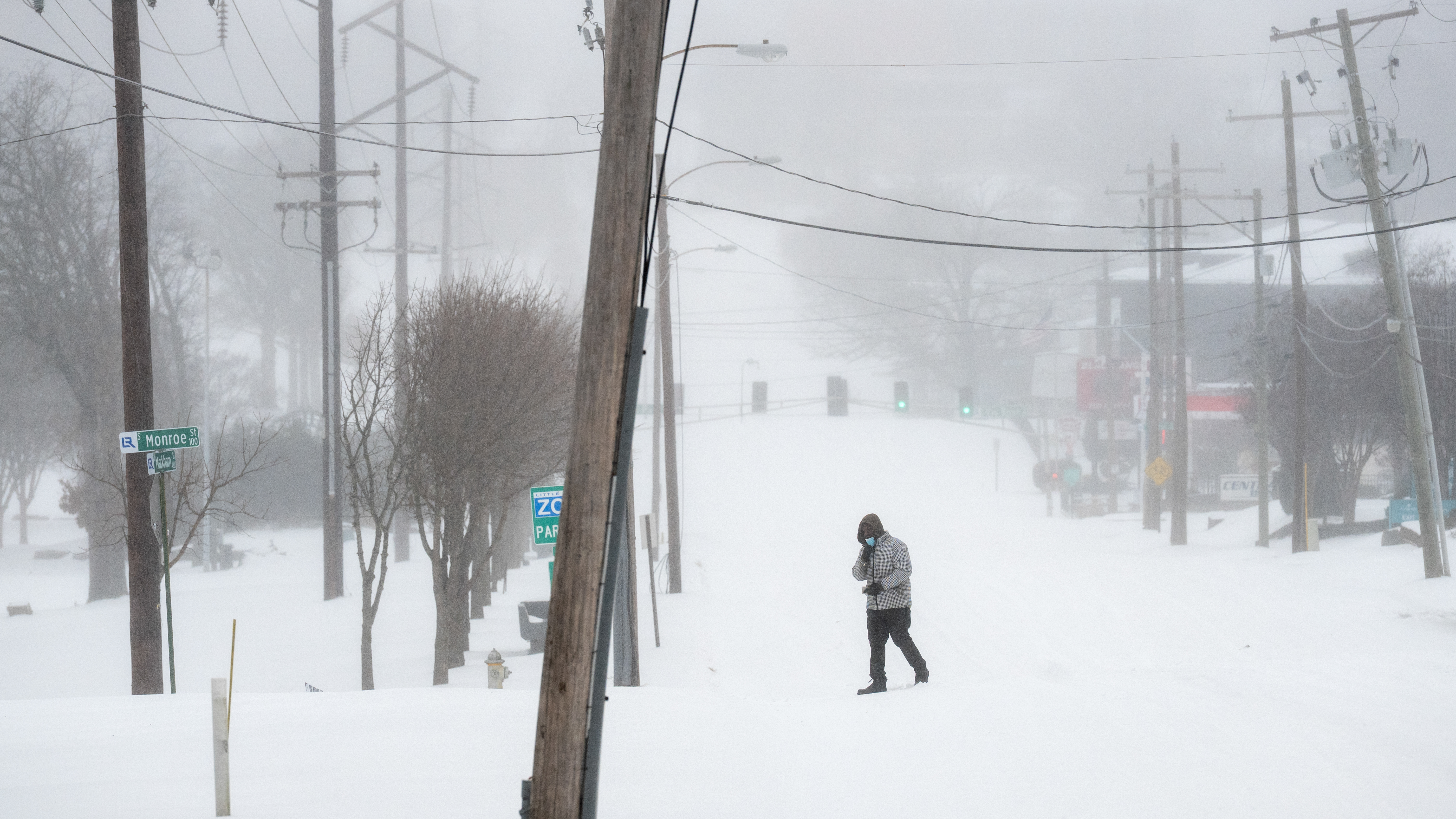 A person walks in the snow on Markham street January 24, 2026 in Little Rock, Arkansas. A massive winter storm is bringing frigid temperatures, ice, and snow to nearly 200 million Americans.