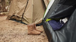 Shot of tents and boots at a campsite out in nature