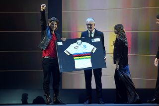 Peter Sagan salutes the crowd as he receives a framed rainbow jersey from Brian Cookson