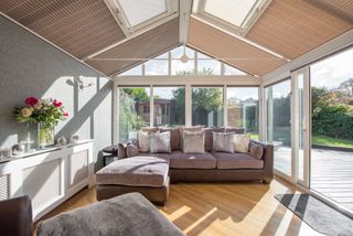 living room conservatory with blinds and wooden flooring