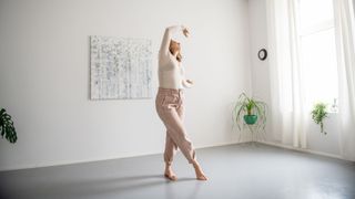 Woman practising barre at home