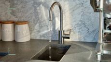 boiling water tap with marble backsplash and grey quartz worktops to support a guide on what you need to know before buying a boiling water tap