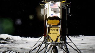 an rectangular spacecraft covered in gold foil and solar panels on the grey dusty surface of the moon