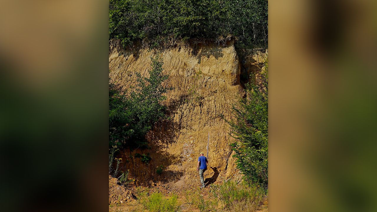 Man at the bottom a a hillside.