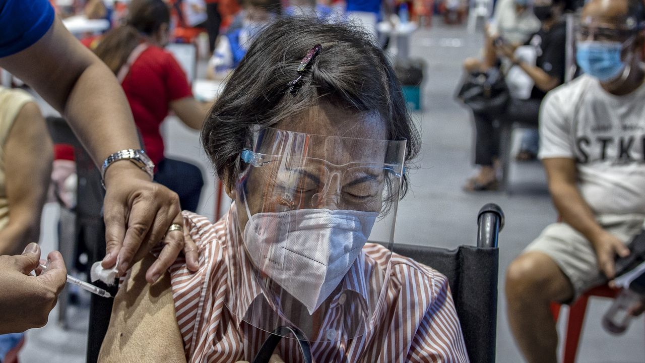 An elderly lady receives a Covid vaccine in San Juan, Philippines