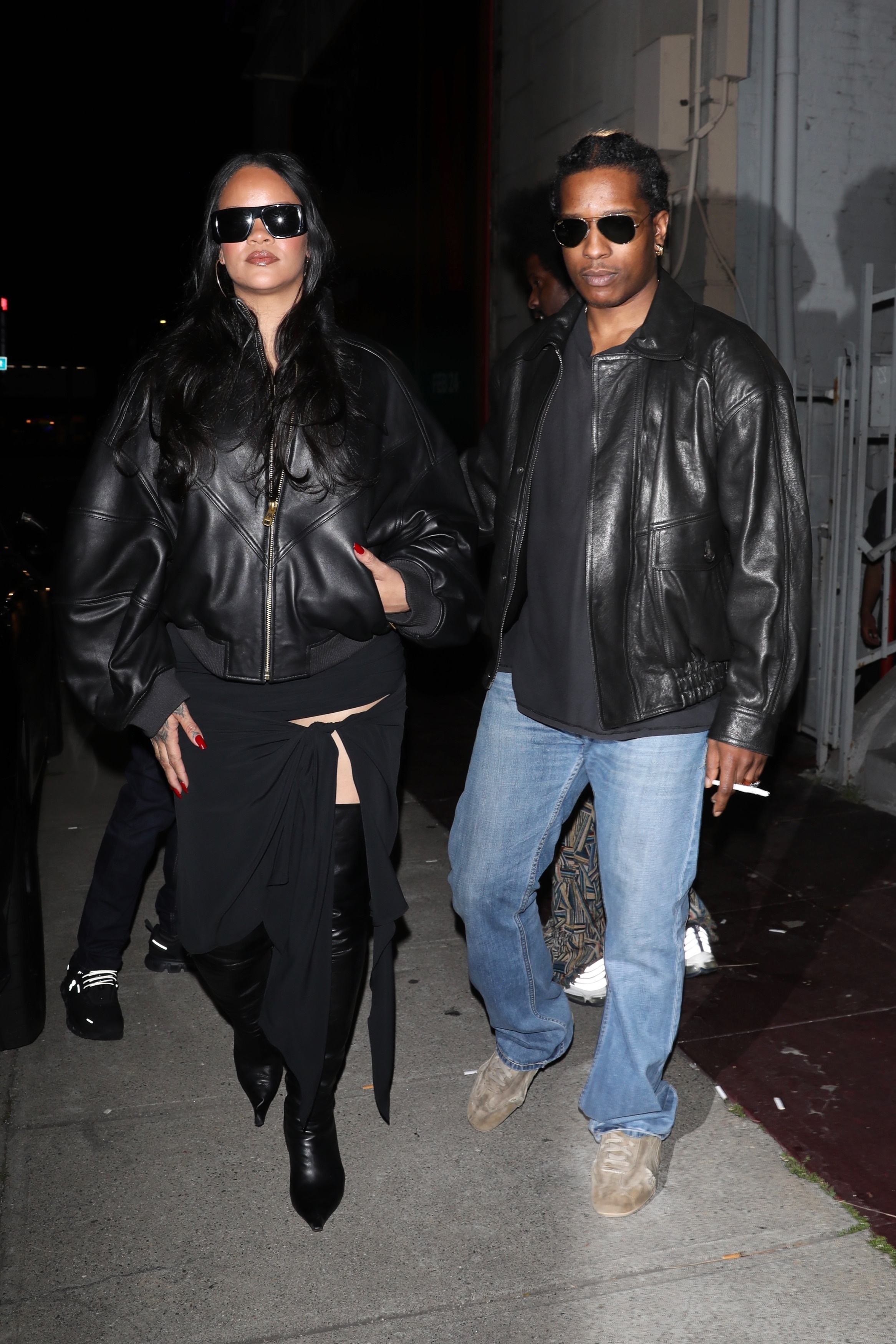 Rihanna and A$AP Rocky coordinated in black leather jackets, with RiRi in over-the-knee leather boots