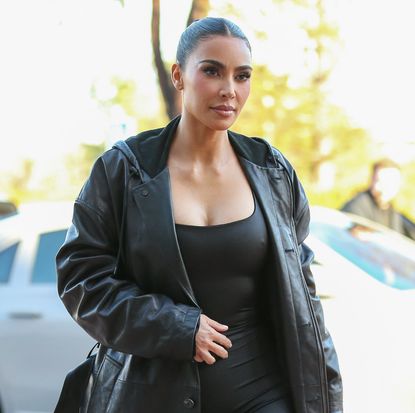  Kim Kardashian wearing a black leather trench coat