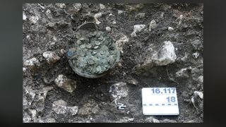 The coin pot contains 1,290 Roman coins.