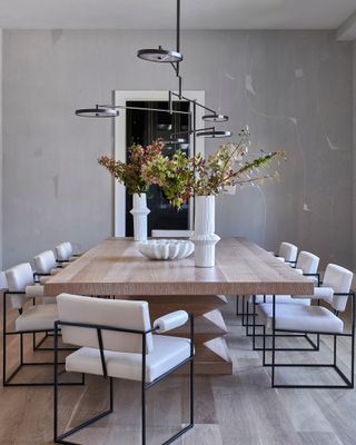 Dining room with wooden dining table and white chairs