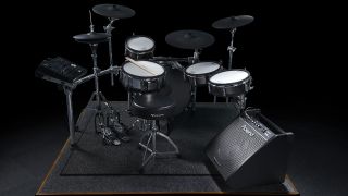 A Roland e-kit on a rider with a Roland PM-200 monitor sat on the floor