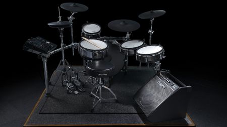 A Roland e-kit on a rider with a Roland PM-200 monitor sat on the floor