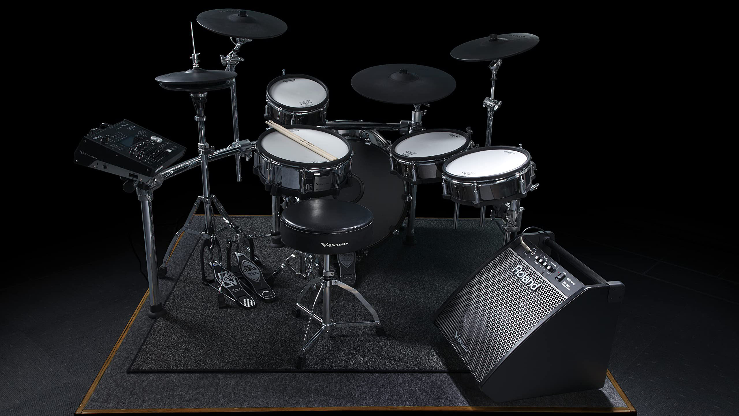A Roland e-kit on a rider with a Roland PM-200 monitor sat on the floor